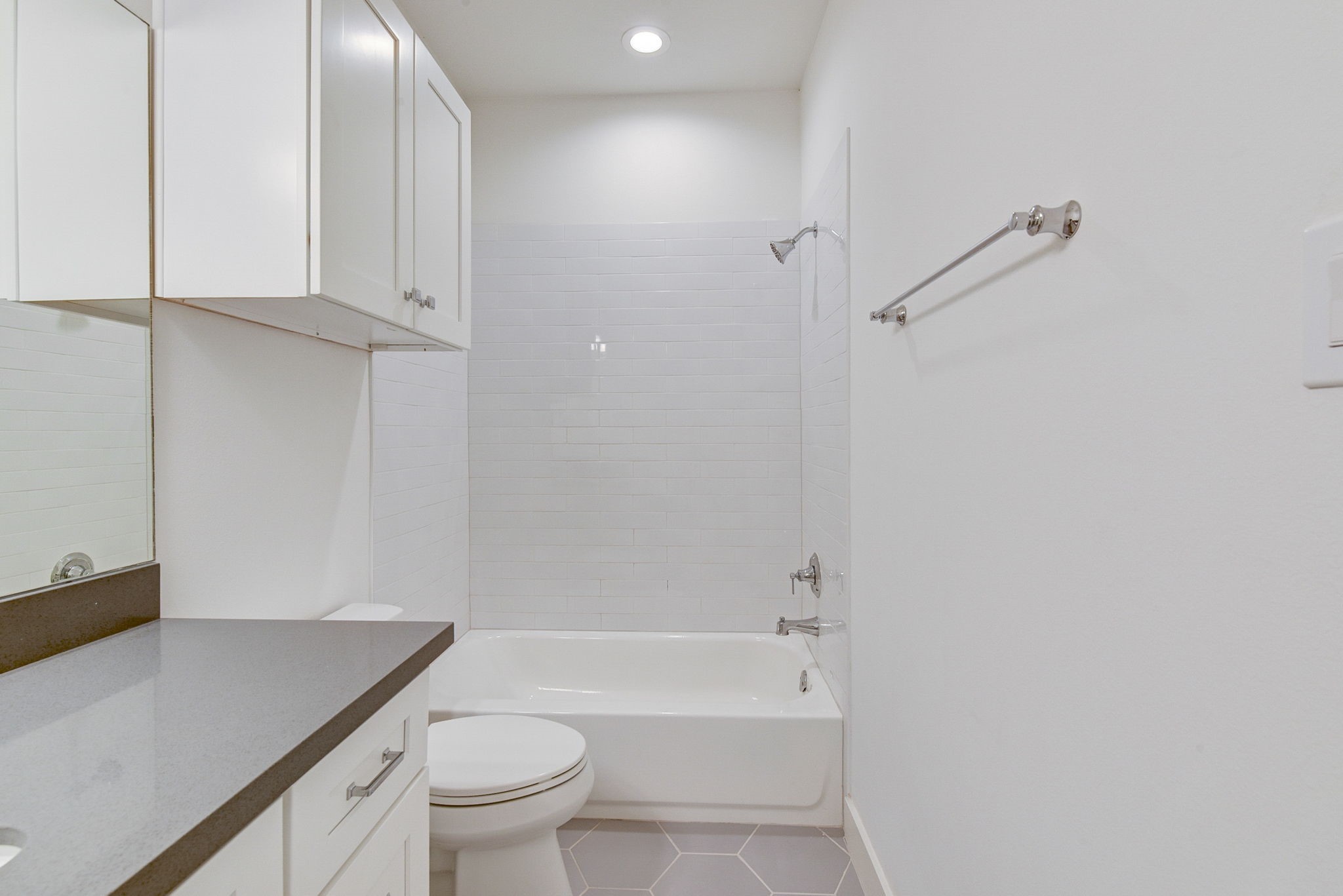 2575 Judiway Street Houston, TX 77018 - Photo 18 of 48 a bathroom with a granite countertop sink a toilet and shower