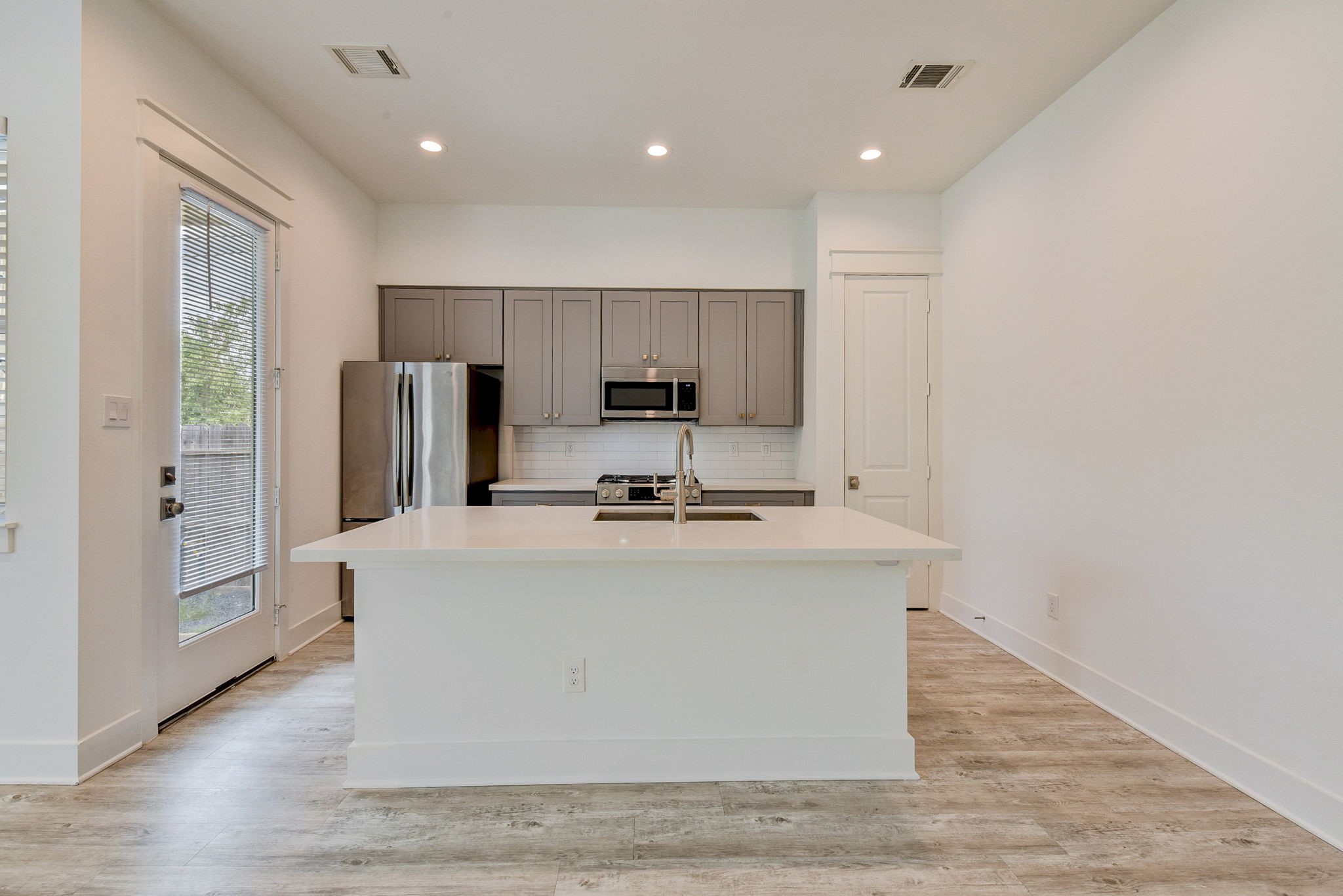 2575 Judiway Street Houston, TX 77018 - Photo 34 of 48 a view of kitchen with stainless steel appliances granite countertop a stove top oven a sink and a refrigerator