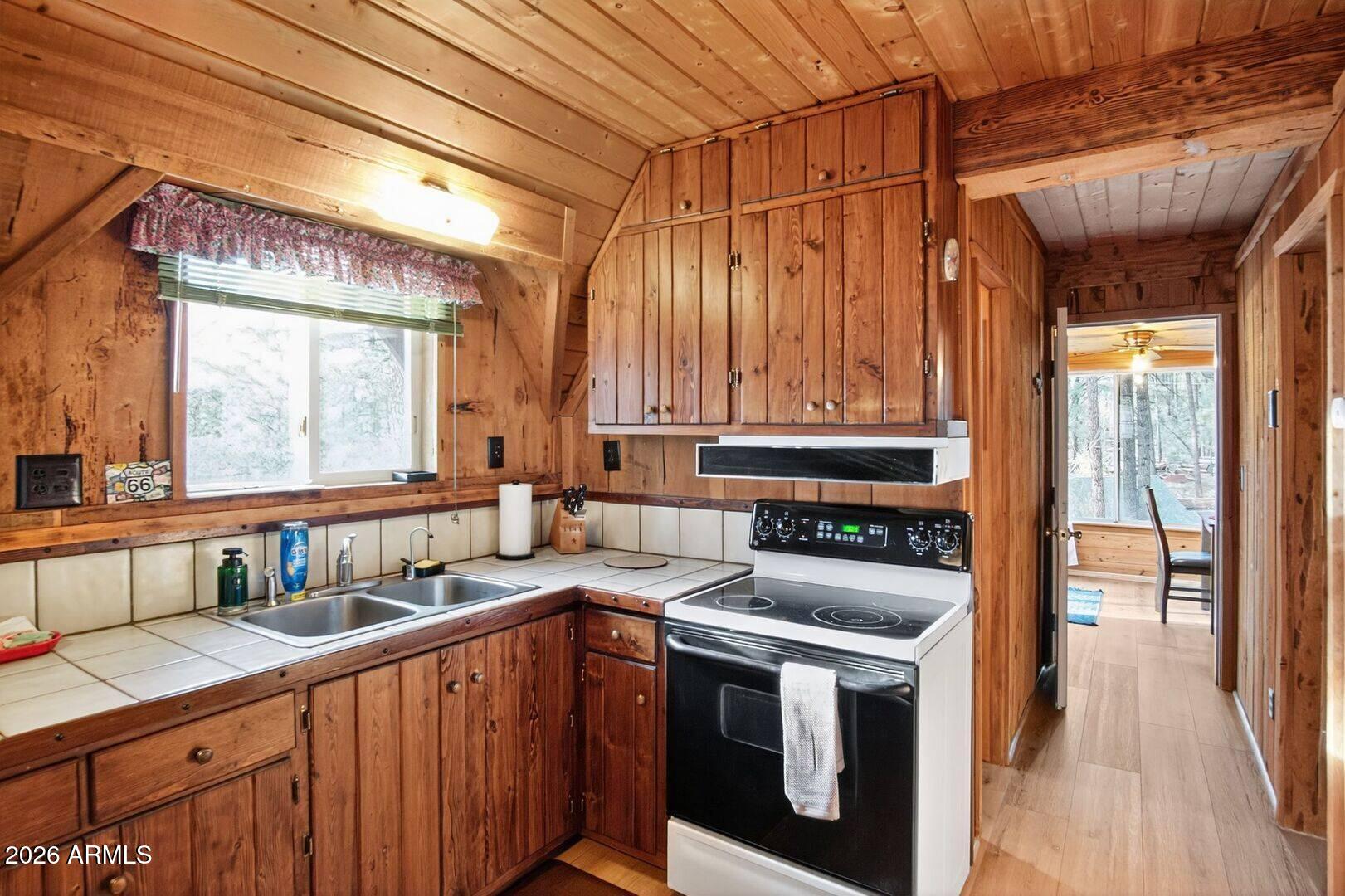 8884 Tonto Rim Drive Pine, AZ 85544 - Photo 19 of 43 a kitchen with a stove and a sink