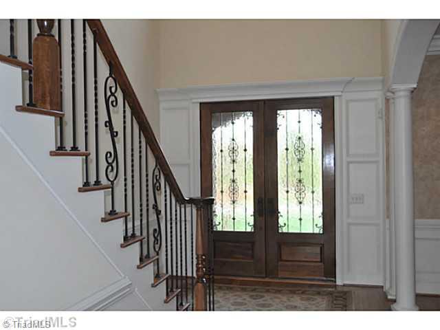 7045 Denison Road Summerfield, NC 27358 - Photo 1 of 16 Entry. A dramatic two story foyer is entered through bespoke Mahogany doors with wrought iron grilles.