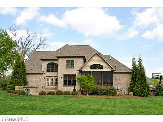 7045 Denison Road Summerfield, NC 27358 - Photo 15 of 16 Exterior Back. The back view of this fine home shows how the screened porch and terrace work in concert to create an outstanding outdoor living room.