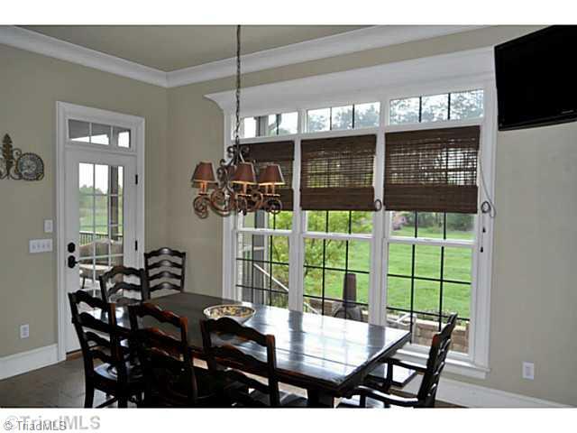 7045 Denison Road Summerfield, NC 27358 - Photo 5 of 16 Breakfast. The gourmet kitchen opens directly into this spacious breakfast room with its great backyard and terrace view.