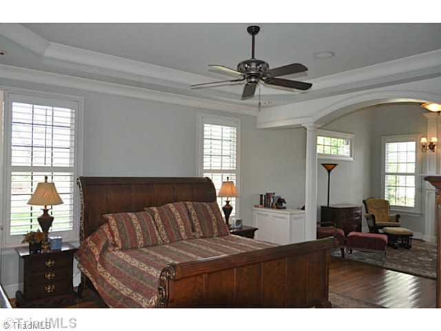 7045 Denison Road Summerfield, NC 27358 - Photo 9 of 16 Master Bedroom. The first floor master suite with its sitting room and spa bath takes up the entire east wing of this fine home.
