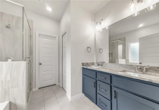 a bathroom with a granite countertop sink mirror and double