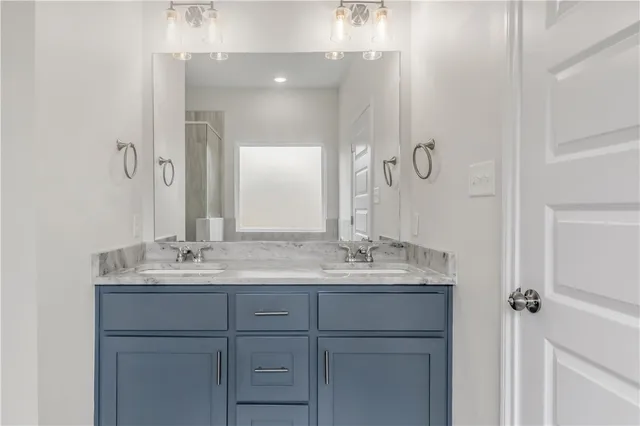 a bathroom with a double vanity sink and mirror