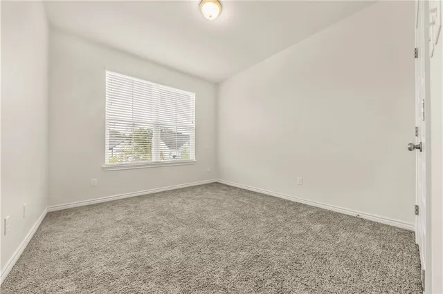 a bathroom with a granite countertop sink a toilet and mirror