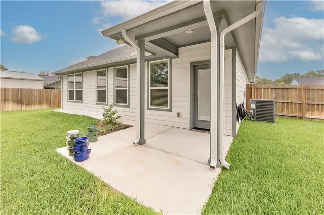 a view of a house with a yard and sitting area