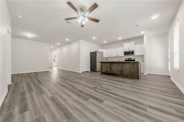 a view of a kitchen with a sink and a stove top oven