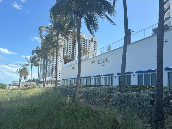 a view of a building with a yard
