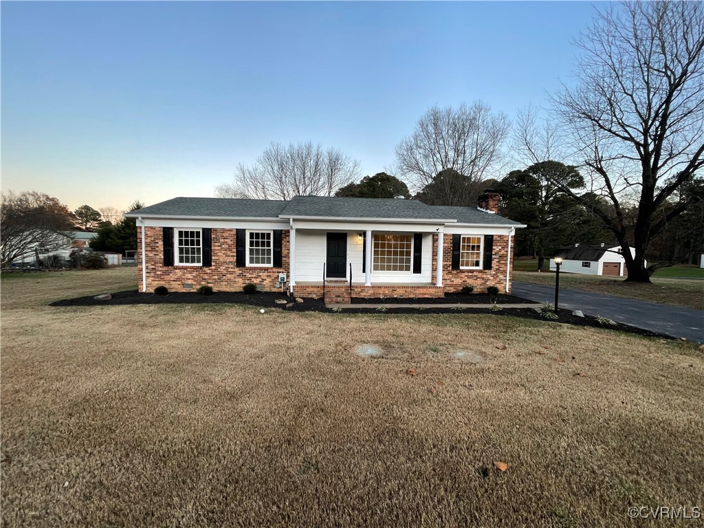 7617 Strath Road Henrico, VA 23231 - Photo 1 of 25 a front view of a house with a garden