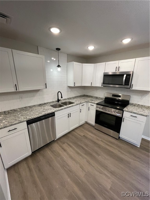 7617 Strath Road Henrico, VA 23231 - Photo 15 of 25 a kitchen with granite countertop a stove top oven and cabinets