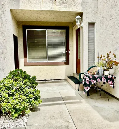 a front view of a house with outdoor seating