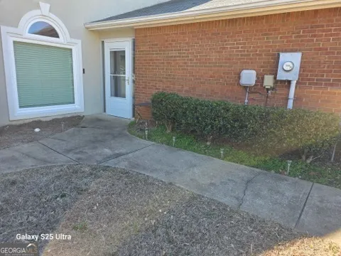 a view of a brick wall and table in front of house