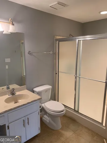 a white toilet sitting next to a bathroom sink