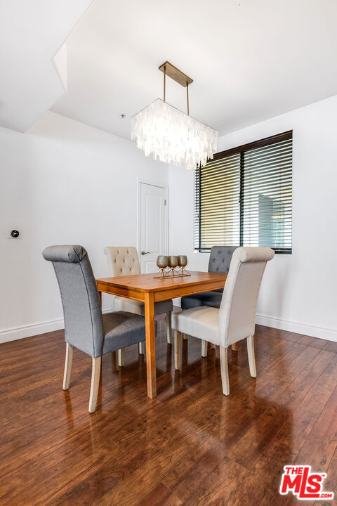 4724 Kester Avenue, Unit 209 Sherman Oaks, CA 91403 - Photo 13 of 27 a view of a dining room with furniture window and wooden floor