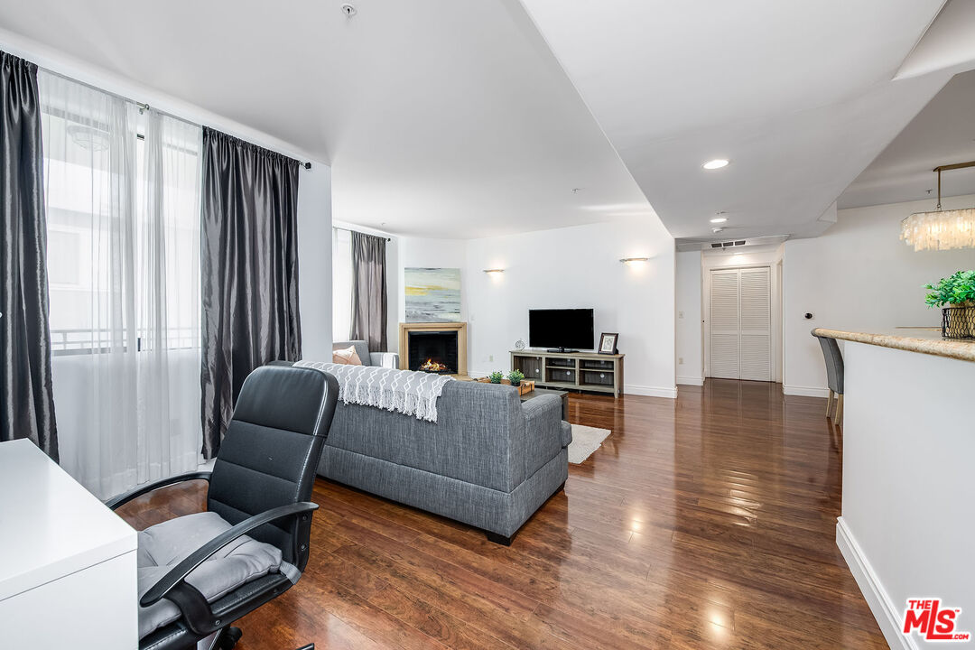 4724 Kester Avenue, Unit 209 Sherman Oaks, CA 91403 - Photo 16 of 27 a living room with furniture and a flat screen tv