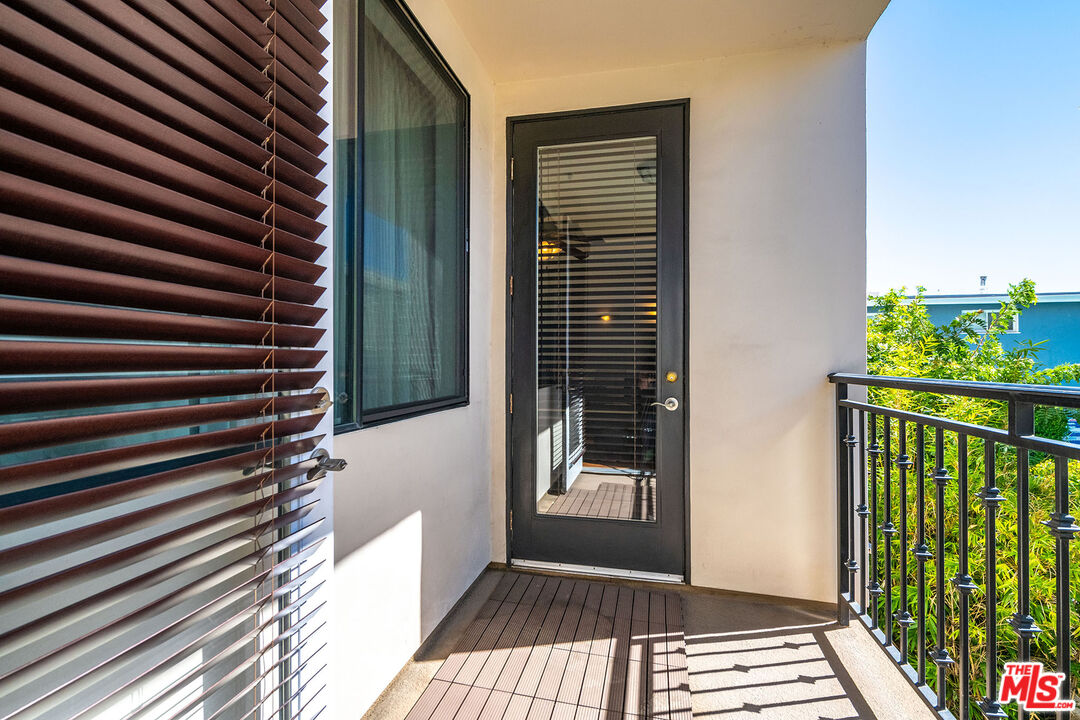 4724 Kester Avenue, Unit 209 Sherman Oaks, CA 91403 - Photo 22 of 27 a view of a balcony with wooden floor