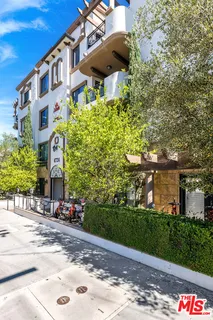 a front view of a building with an outdoor space and seating