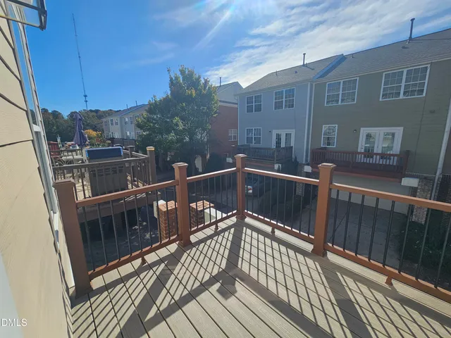 a view of balcony with wooden floor and fence