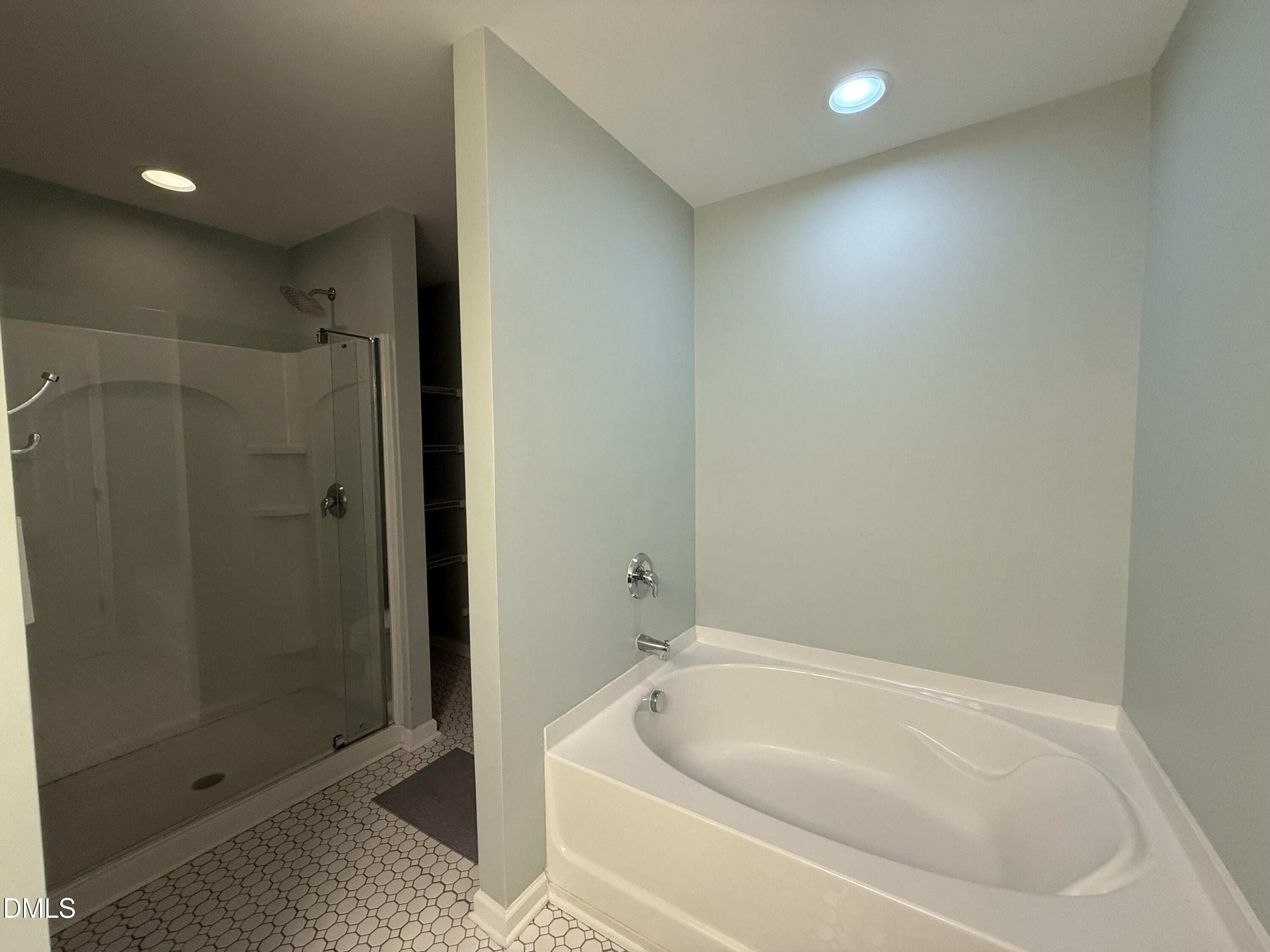 606 Sawcut Lane Apex, NC 27502 - Photo 20 of 30 a bathroom with a tub and shower