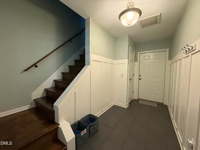 a view of entryway and hall with wooden floor