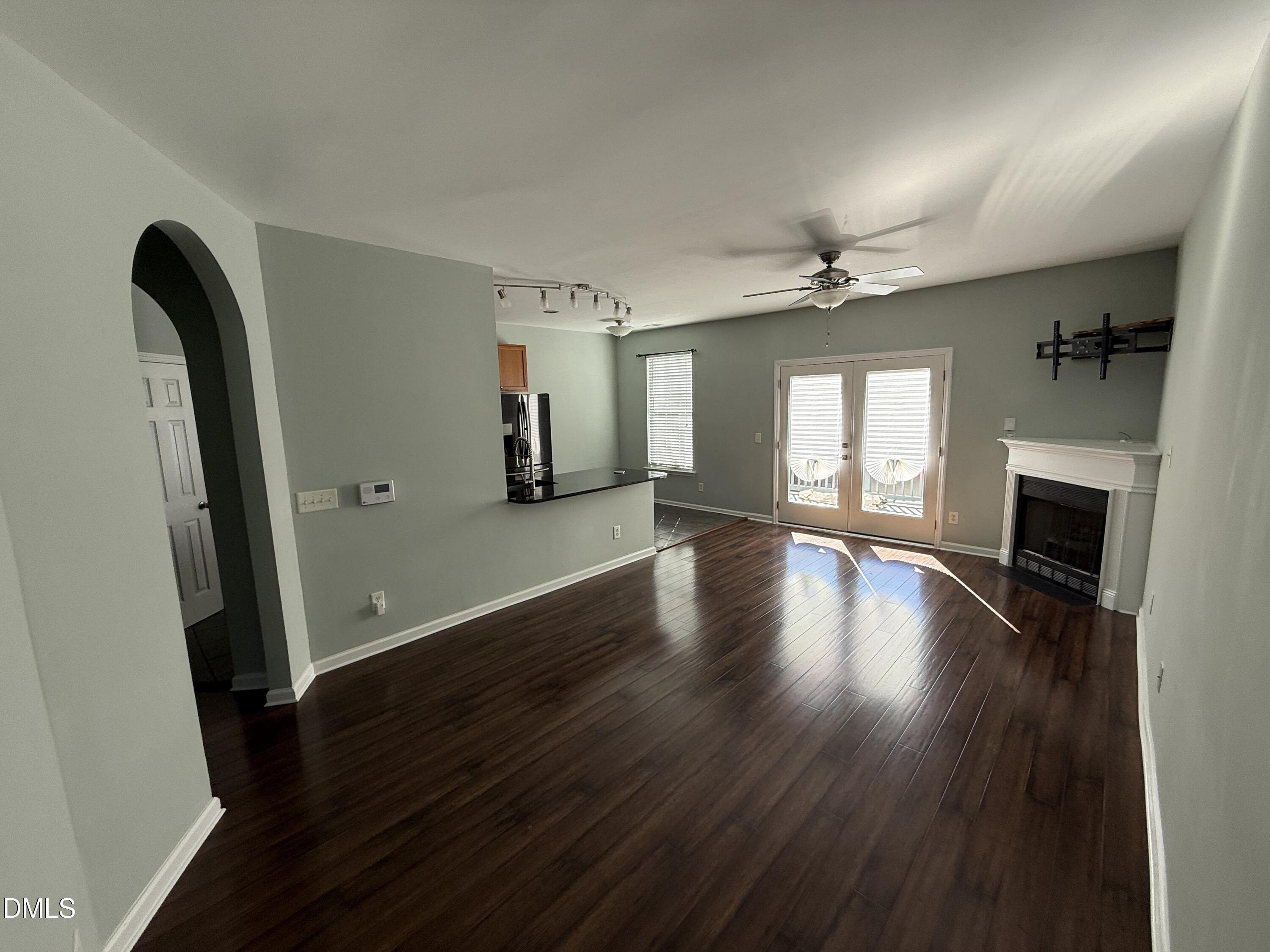 606 Sawcut Lane Apex, NC 27502 - Photo 5 of 30 an empty room with wooden floor and a fireplace