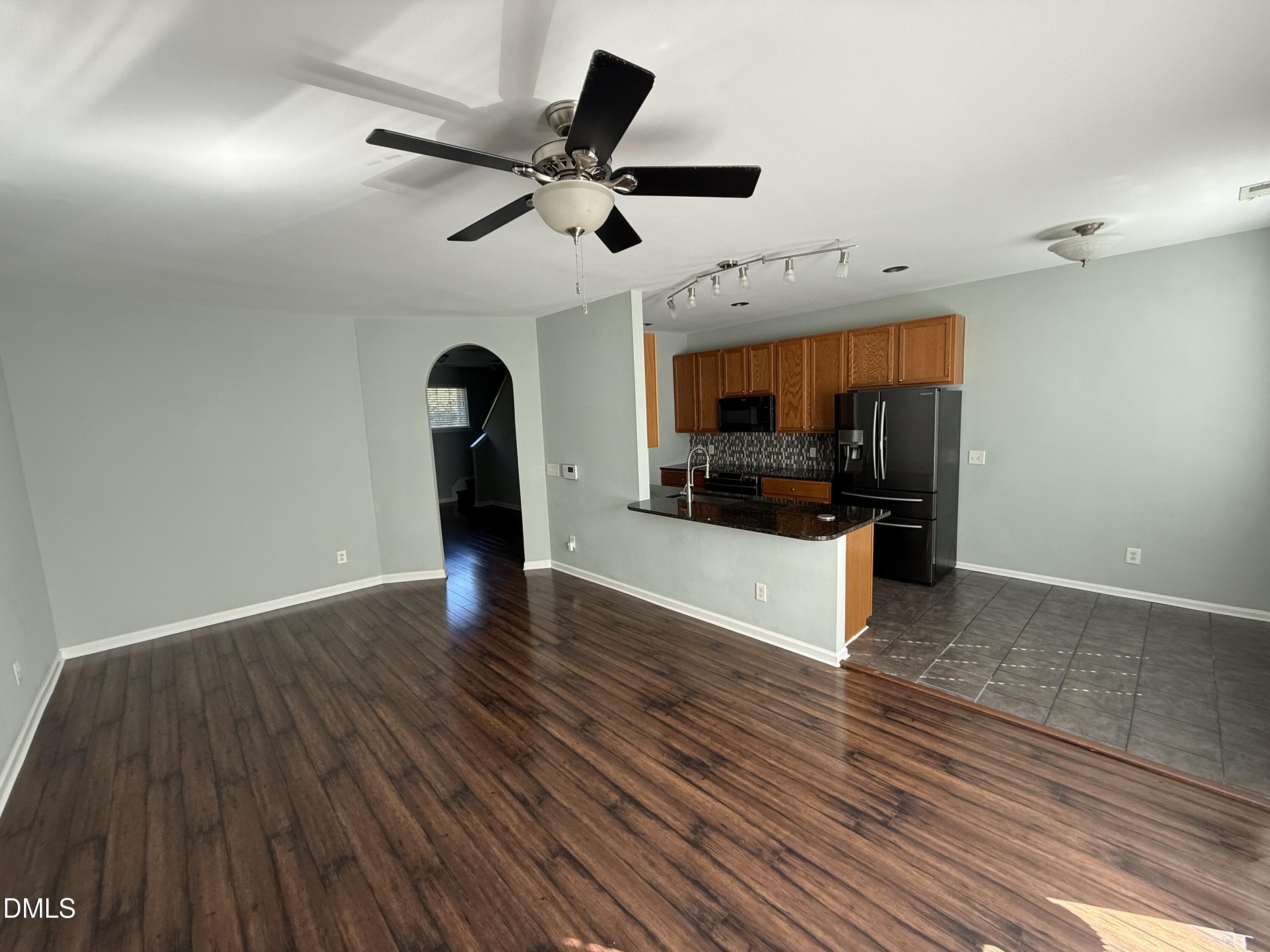 606 Sawcut Lane Apex, NC 27502 - Photo 6 of 30 a view of a kitchen with a sink and a ceiling fan