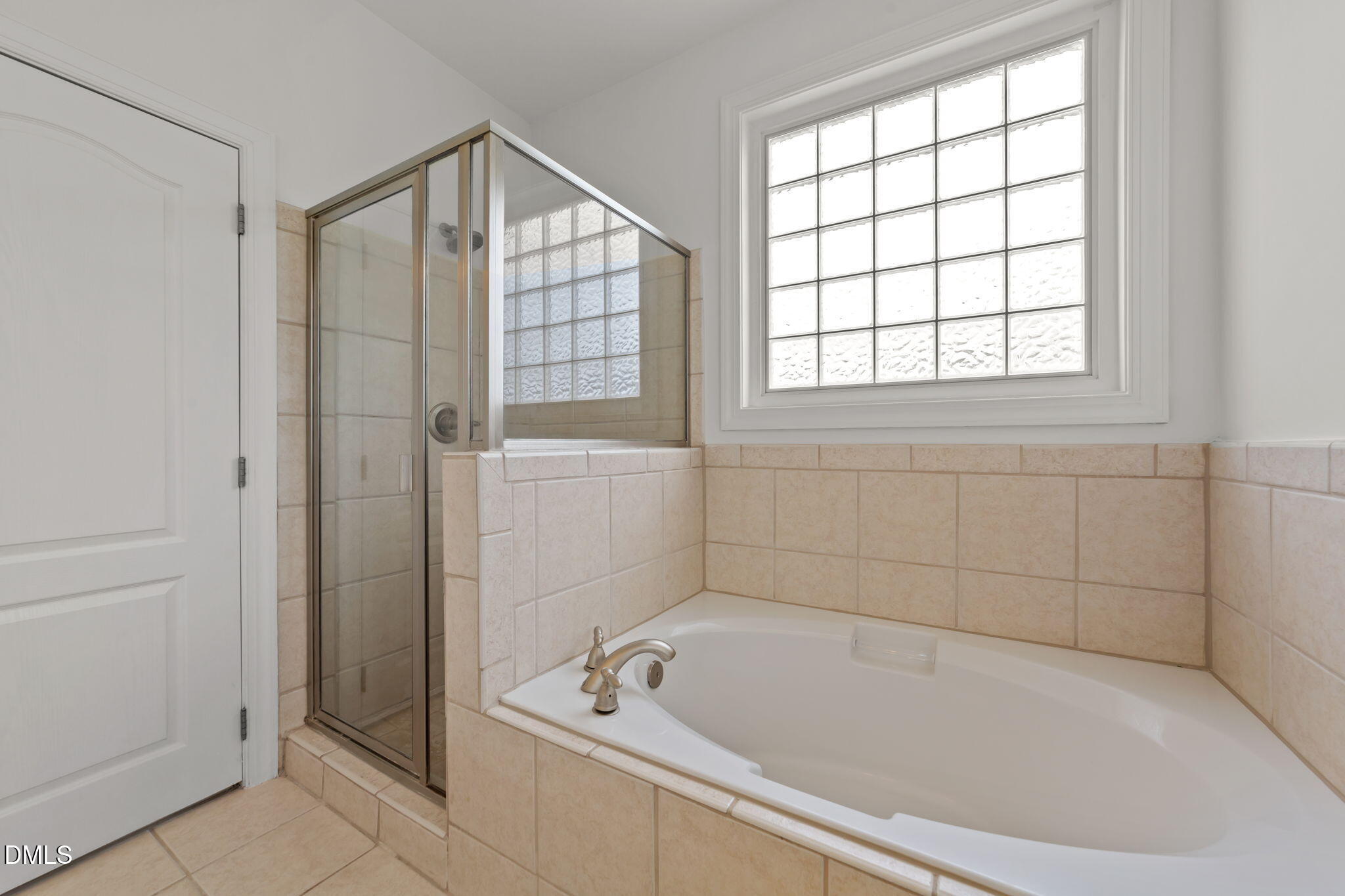 7101 Numa Circle Willow Spring, NC 27592 - Photo 16 of 44 a bathroom with a bathtub and a shower