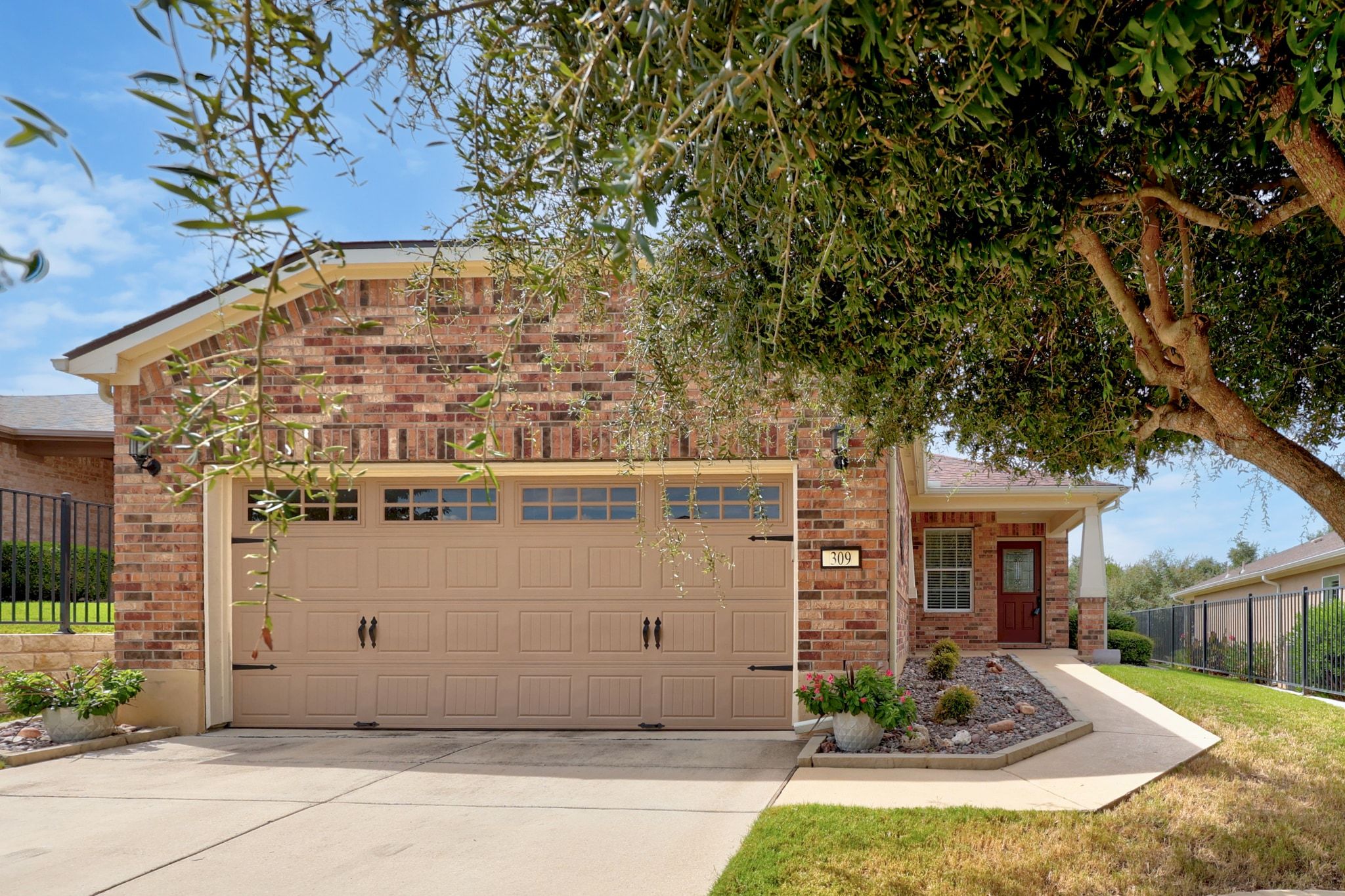 a front view of a house with garden