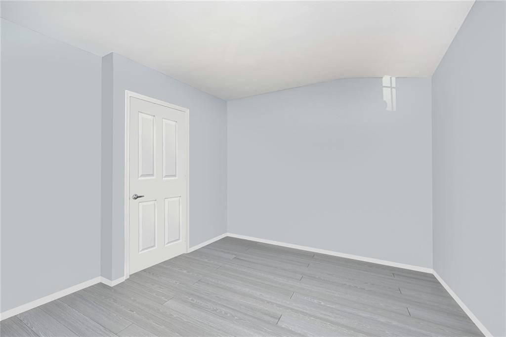 206 Rosedale Avenue Staten Island, NY 10312 - Photo 12 of 19 a view of an empty room and wooden floor