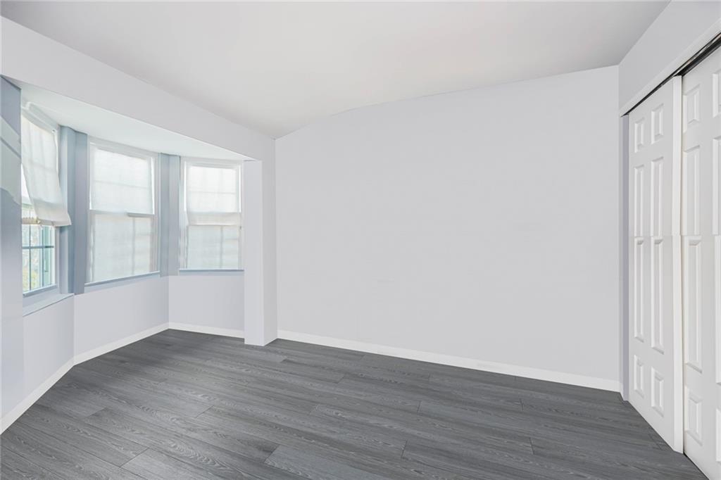 206 Rosedale Avenue Staten Island, NY 10312 - Photo 13 of 19 wooden floor in an empty room with a window
