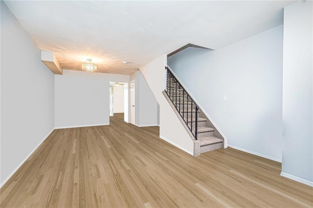 206 Rosedale Avenue Staten Island, NY 10312 - Photo 3 of 19 a view of a hallway with wooden floor and staircase