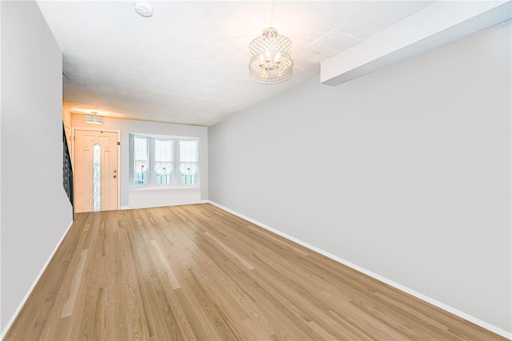 206 Rosedale Avenue Staten Island, NY 10312 - Photo 4 of 19 a view of an empty room with wooden floor and a window