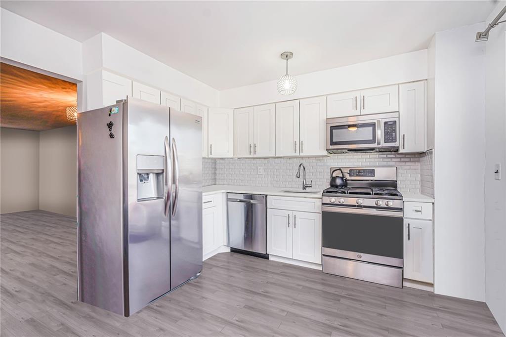 206 Rosedale Avenue Staten Island, NY 10312 - Photo 5 of 19 a kitchen with stainless steel appliances a refrigerator stove and microwave