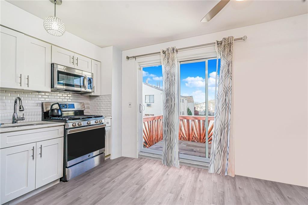 206 Rosedale Avenue Staten Island, NY 10312 - Photo 6 of 19 a kitchen with granite countertop a sink stove and cabinets