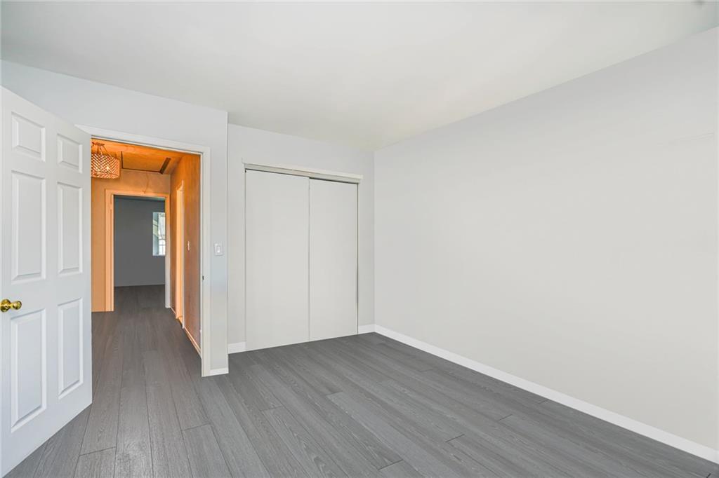 206 Rosedale Avenue Staten Island, NY 10312 - Photo 8 of 19 a view of an empty room with wooden floor and closet