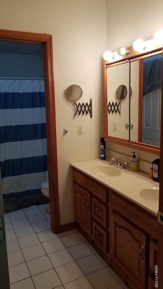 185 Fox Road Dingmans Ferry, PA 18328 - Photo 11 of 19 a bathroom with a double vanity sink and a mirror