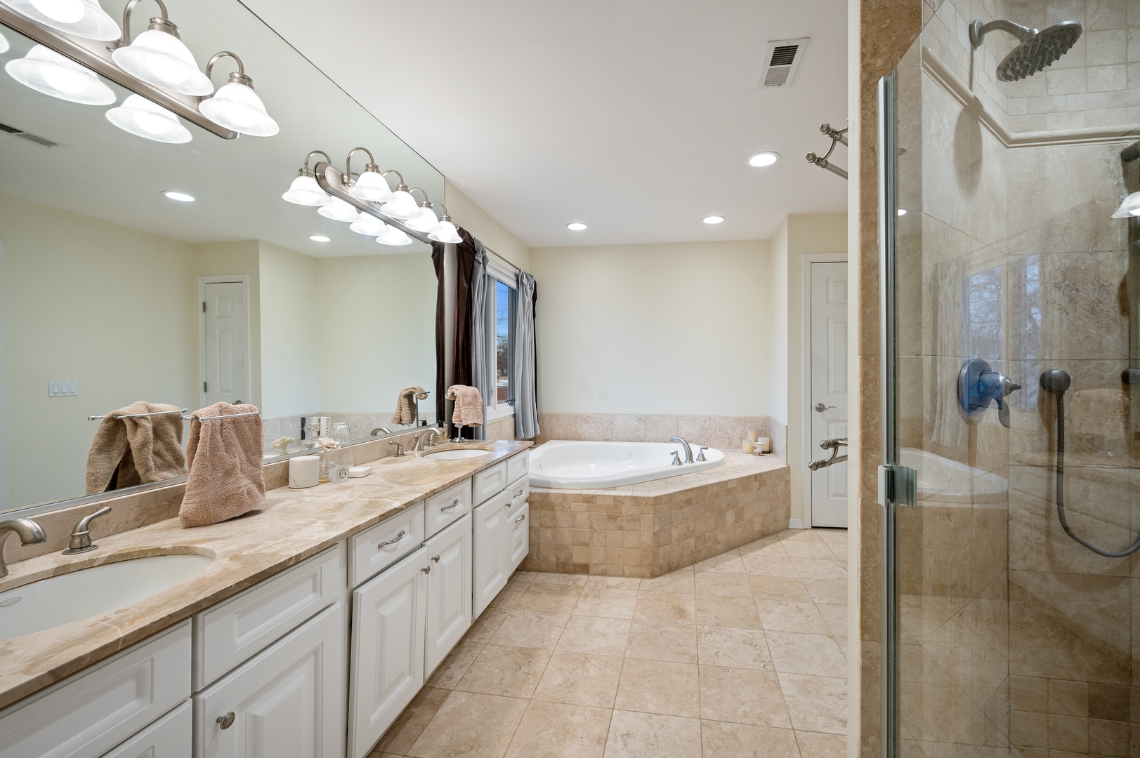 1111 Harms Road Glenview, IL 60025 - Photo 11 of 14 a bathroom with a double vanity sink a large mirror and shower