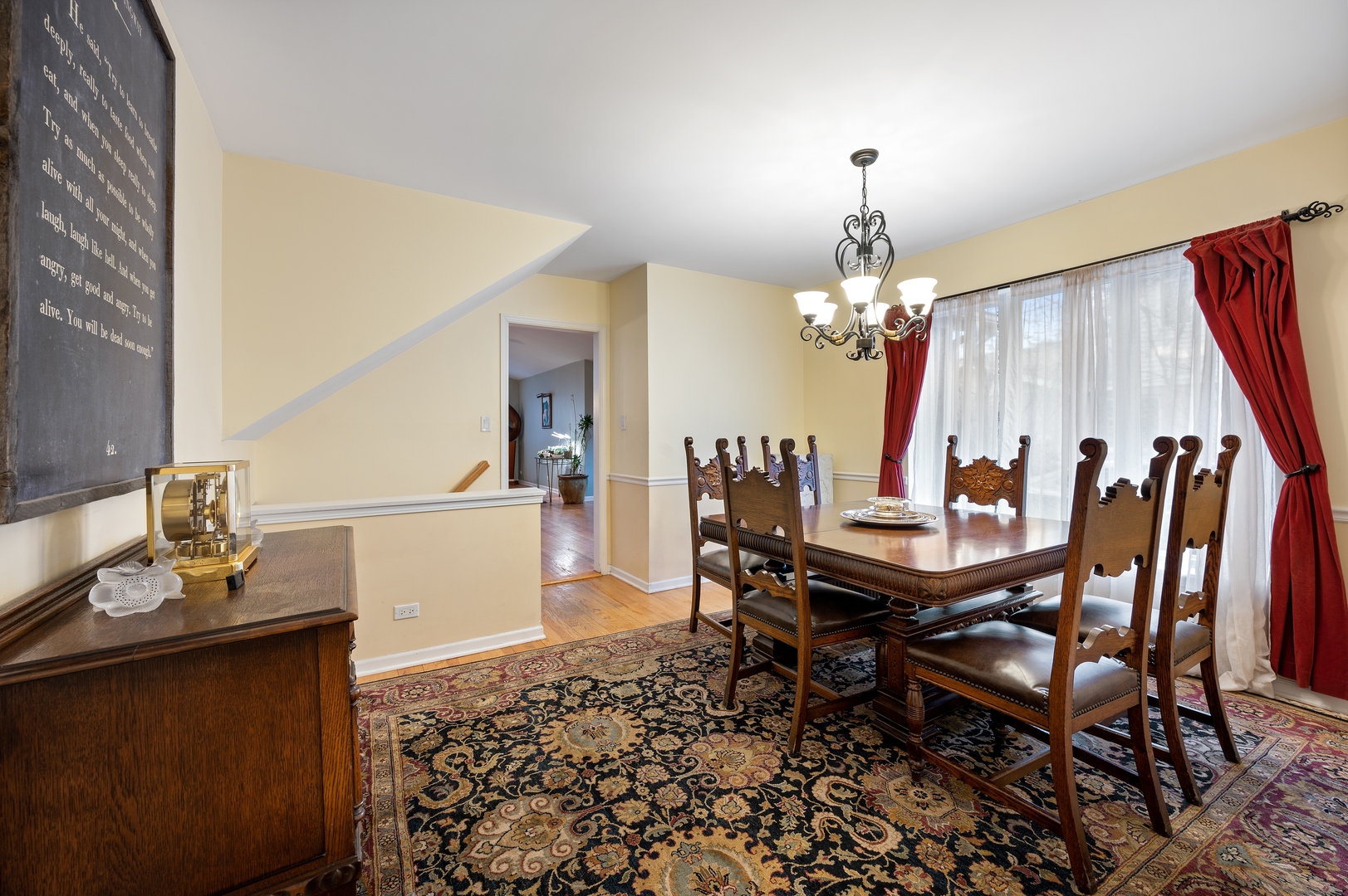 1111 Harms Road Glenview, IL 60025 - Photo 4 of 14 a dining room with furniture a chandelier and wooden floor