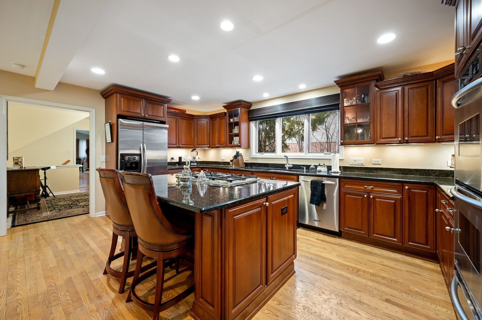 1111 Harms Road Glenview, IL 60025 - Photo 5 of 14 a kitchen with stainless steel appliances granite countertop a stove a sink dishwasher and a refrigerator