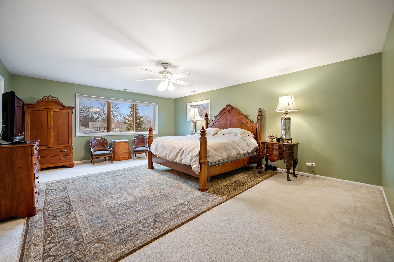 1111 Harms Road Glenview, IL 60025 - Photo 10 of 14 a spacious bedroom with a bed and a chandelier