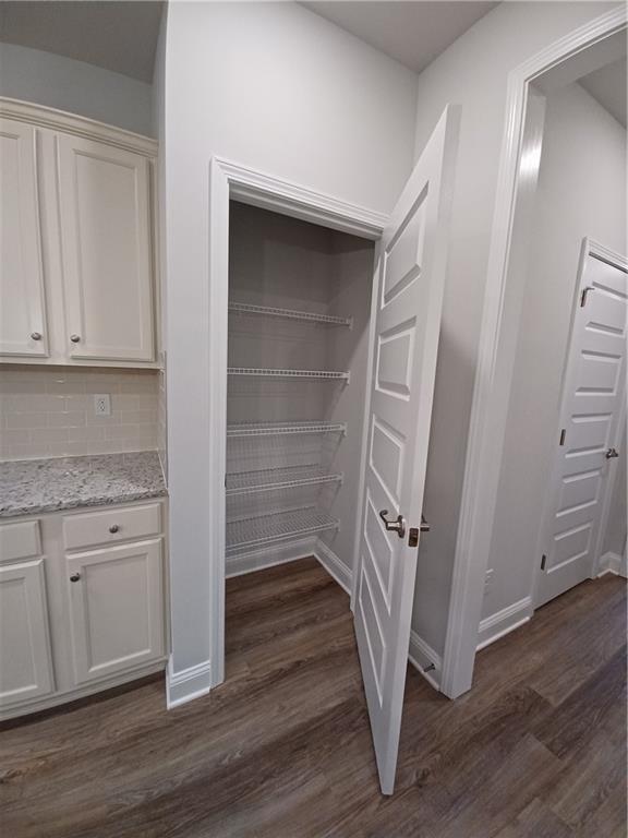 534 Creek Road Cornelia, GA 30531 - Photo 8 of 11 a view of an empty room with wooden floor and a cabinet