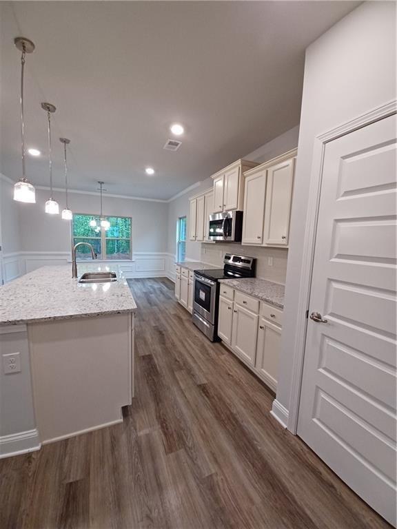 534 Creek Road Cornelia, GA 30531 - Photo 9 of 11 a kitchen with kitchen island granite countertop a sink cabinets and stainless steel appliances