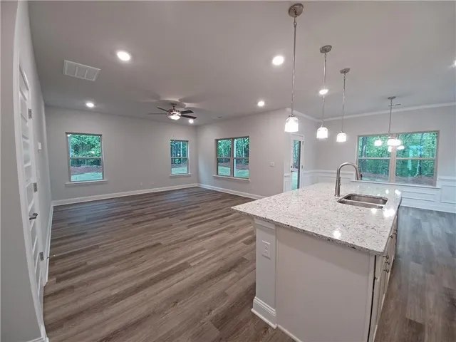 a kitchen with kitchen island a sink stainless steel appliances and window