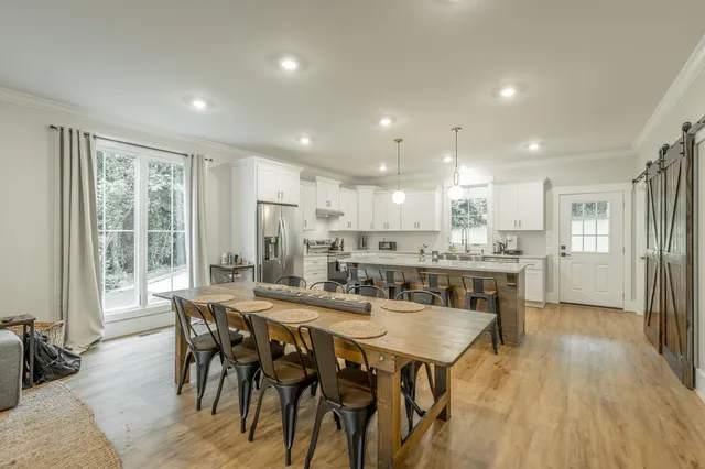 a large kitchen with a table and chairs