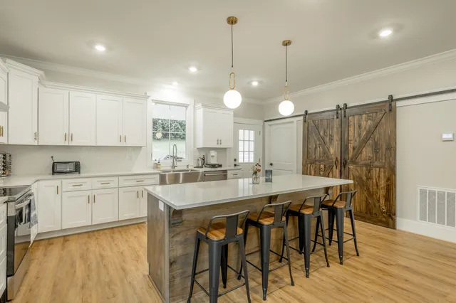 a kitchen with cabinets stainless steel appliances and a sink