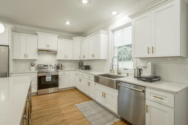 a large kitchen with kitchen island a sink table and chairs