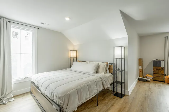 a room with gym equipment and a wooden floor