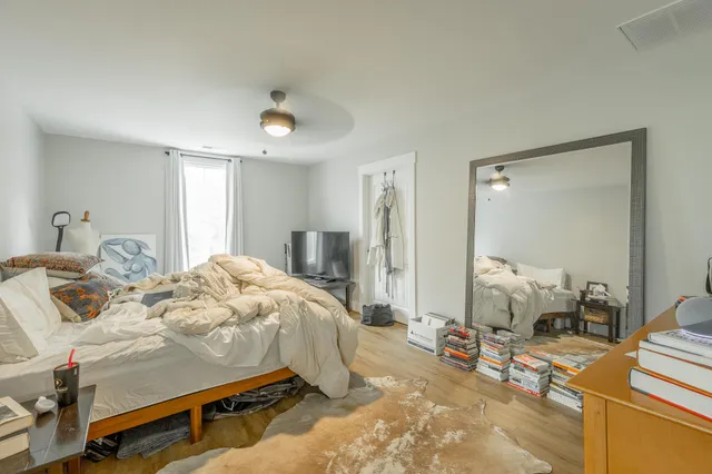 a bedroom with furniture and a closet