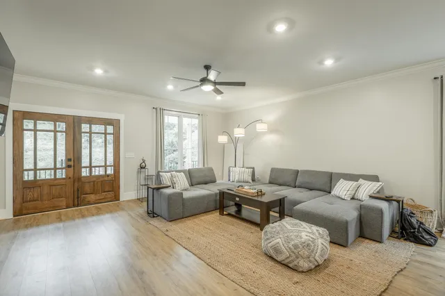 a living room with furniture and kitchen view